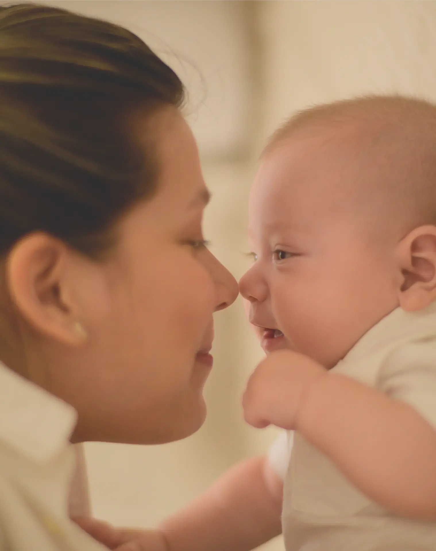 Mother gently kissing her baby